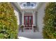 Inviting entryway featuring a red double door and decorative plants at 4743 Spinnaker Dr, Bradenton, FL 34208