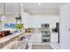 Updated kitchen featuring stainless appliances, granite counters, and a breakfast bar overlooking the living area at 4743 Spinnaker Dr, Bradenton, FL 34208