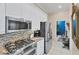 Updated kitchen featuring stainless appliances, granite counters, and access to the dining room at 4743 Spinnaker Dr, Bradenton, FL 34208
