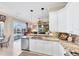 Bright kitchen with white cabinets, granite countertops, stainless steel appliances, and pool view at 4743 Spinnaker Dr, Bradenton, FL 34208