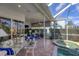 Spacious covered lanai with comfortable seating and serene views of the pool and backyard at 4743 Spinnaker Dr, Bradenton, FL 34208