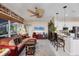 Open-concept living room with ceiling fan, bar seating, and view to the kitchen and lanai at 4743 Spinnaker Dr, Bradenton, FL 34208