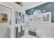 A beautifully designed main bathroom with a tub, shower, white cabinets and lots of natural light at 4743 Spinnaker Dr, Bradenton, FL 34208