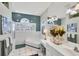 This main bathroom offers a large tub, white cabinets, large mirror and plenty of natural light at 4743 Spinnaker Dr, Bradenton, FL 34208