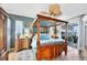 Serene main bedroom with hardwood floors, four poster bed, and sliding glass door to lanai at 4743 Spinnaker Dr, Bradenton, FL 34208