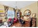 This office features hardwood floors, bright light, two work spaces and a comfortable red sofa at 4743 Spinnaker Dr, Bradenton, FL 34208