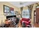 Functional office with three screens, desk, bookshelf and comfortable red sofa at 4743 Spinnaker Dr, Bradenton, FL 34208