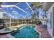 Inviting screened pool and spa area with a brick deck, offering a private outdoor oasis at 4743 Spinnaker Dr, Bradenton, FL 34208