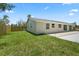 Home featuring a large grassy backyard and private fence at 561 Golf And Sea Blvd, Apollo Beach, FL 33572