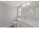 Elegant bathroom featuring a vanity with a white quartz countertop and a beautifully tiled walk-in shower at 561 Golf And Sea Blvd, Apollo Beach, FL 33572