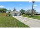 Attractive single-story home featuring a spacious front lawn, new fence, and a long concrete driveway at 561 Golf And Sea Blvd, Apollo Beach, FL 33572