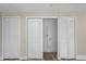 Hallway with wood floors and closet leading to laundry area at 561 Golf And Sea Blvd, Apollo Beach, FL 33572