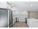 Modern kitchen features new stainless steel appliances, white cabinetry, and quartz countertops at 561 Golf And Sea Blvd, Apollo Beach, FL 33572