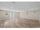 Spacious living room with wood floors, recessed lighting and access to the backyard at 561 Golf And Sea Blvd, Apollo Beach, FL 33572
