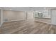 Open concept living area featuring new vinyl plank flooring that connects to an adjacent kitchen at 561 Golf And Sea Blvd, Apollo Beach, FL 33572