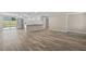 Open living space featuring wood floors, kitchen with stainless steel appliances and backyard access at 561 Golf And Sea Blvd, Apollo Beach, FL 33572