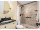 Bathroom with tiled shower, modern fixtures, and granite countertop at 5623 80Th N St # 415, St Petersburg, FL 33709