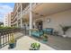 Exterior view of building entrance with benches, potted plants, and manicured landscaping at 5623 80Th N St # 415, St Petersburg, FL 33709