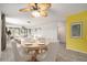 Bright dining room with a table, ceiling fan, and view into the living room at 5623 80Th N St # 415, St Petersburg, FL 33709
