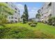 Exterior lawn area between building with well maintained grass and shrubs at 5623 80Th N St # 415, St Petersburg, FL 33709
