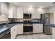 Kitchen featuring white cabinets, stainless steel appliances and blue countertop at 5623 80Th N St # 415, St Petersburg, FL 33709