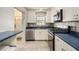 Kitchen featuring white cabinets, stainless steel appliances and blue countertop at 5623 80Th N St # 415, St Petersburg, FL 33709