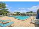Community swimming pool with lounge chairs and shade, perfect for relaxation at 5623 80Th N St # 415, St Petersburg, FL 33709