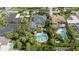 Wide aerial view of the property showcasing the pool, landscaping, and proximity to surrounding neighborhood at 58 Aster St, Clearwater Beach, FL 33767