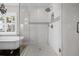 Elegant bathroom features a walk-in shower with glass enclosure and a luxurious soaking tub at 58 Aster St, Clearwater Beach, FL 33767