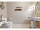 Elegant powder room featuring gold accents, decorative lighting, and classic fixtures at 58 Aster St, Clearwater Beach, FL 33767