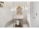 Elegant powder room featuring gold accents, decorative lighting, and classic fixtures at 58 Aster St, Clearwater Beach, FL 33767