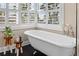 Relaxing bathroom featuring a clawfoot tub and plenty of natural light from the shuttered windows at 58 Aster St, Clearwater Beach, FL 33767