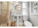Charming bathroom with walk-in shower and pedestal sink at 58 Aster St, Clearwater Beach, FL 33767