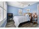 Comfortable bedroom with blue walls, plantation shutters, and stylish furnishings at 58 Aster St, Clearwater Beach, FL 33767
