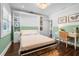 Bright bedroom with Murphy bed, desk, and ample storage space at 58 Aster St, Clearwater Beach, FL 33767