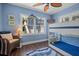 Charming bedroom with blue walls, wood floors, and a fun marlin wall decoration at 58 Aster St, Clearwater Beach, FL 33767