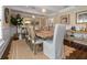 Dining room featuring a rustic wood table, stylish chairs, and views into other living spaces at 58 Aster St, Clearwater Beach, FL 33767