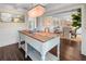 Stunning dining room featuring wood floors, shiplap, and a unique chandelier lighting fixture at 58 Aster St, Clearwater Beach, FL 33767