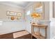 Welcoming foyer with wainscoting, dark floors, a decorative mirror, and coastal accents at 58 Aster St, Clearwater Beach, FL 33767