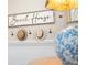 Stylish 'Beach House' sign with hooks, and a decorative blue and white vase at 58 Aster St, Clearwater Beach, FL 33767