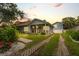 Charming home with lush front yard, a quaint porch, and an inviting driveway with manicured grass at 58 Aster St, Clearwater Beach, FL 33767