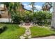 Backyard fire pit area with seating, set in a lush green garden, perfect for relaxation at 58 Aster St, Clearwater Beach, FL 33767