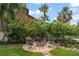 Backyard fire pit area with seating, set in a lush green garden, perfect for relaxation at 58 Aster St, Clearwater Beach, FL 33767
