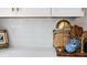 Kitchen featuring white subway tile backsplash and white counters and cabinets at 58 Aster St, Clearwater Beach, FL 33767