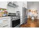 Kitchen featuring stainless steel appliances and white cabinets in modern home at 58 Aster St, Clearwater Beach, FL 33767