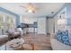 Open-concept living space with white walls, comfortable seating, and a kitchenette area at 58 Aster St, Clearwater Beach, FL 33767