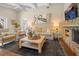 Bright living room featuring a stone fireplace, TV, comfortable seating, and stylish decor at 58 Aster St, Clearwater Beach, FL 33767