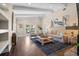Spacious living room with vaulted ceilings, wood floors, and views of the back yard at 58 Aster St, Clearwater Beach, FL 33767