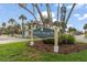 North Beach neighborhood sign on a sunny day, surrounded by lush landscaping and nearby homes at 58 Aster St, Clearwater Beach, FL 33767