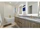 Modern bathroom featuring double vanities, a soaking tub, and sleek fixtures at 5816 S 3Rd St, Tampa, FL 33611